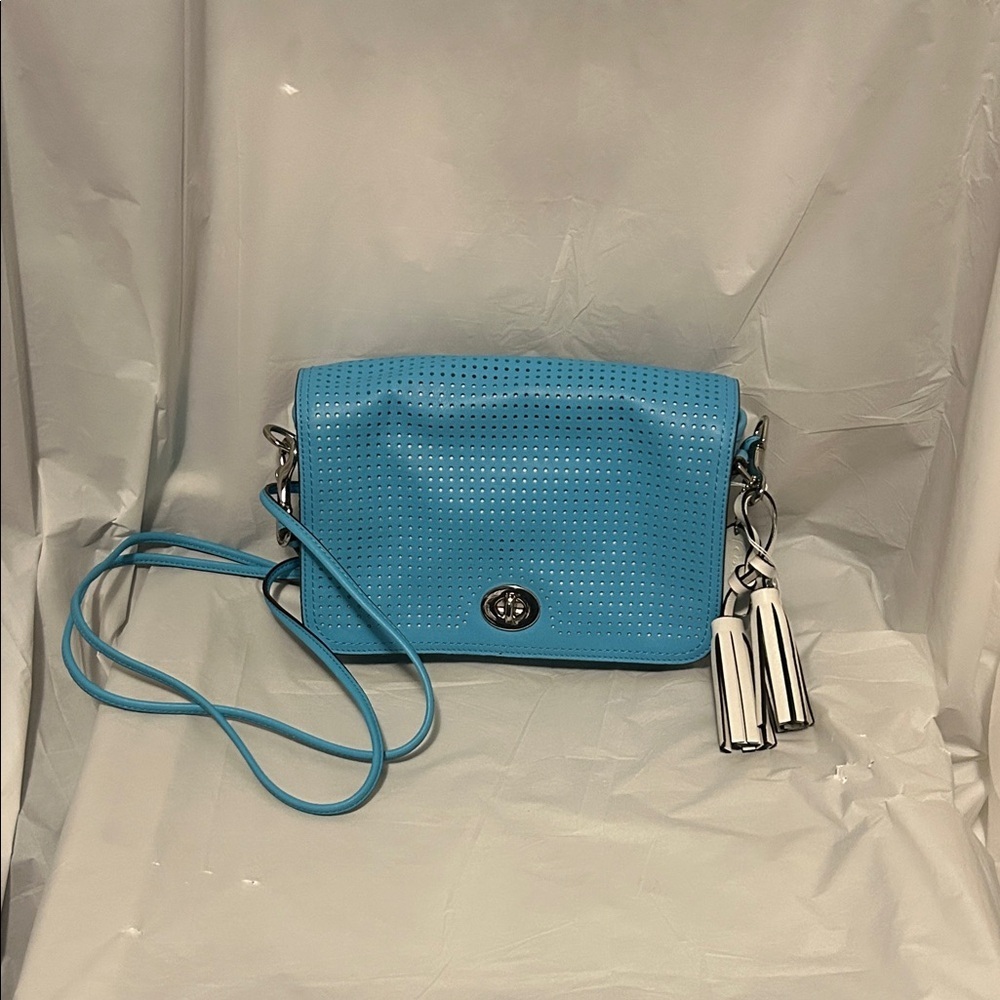 New, never used Coach Blue Perforated Crossbody with Tassel Charm